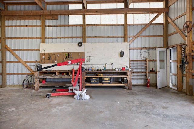 garage featuring a workshop area and metal wall