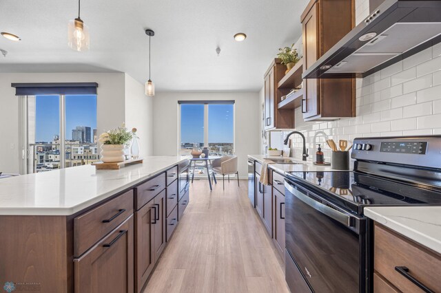 kitchen with range with electric stovetop, open shelves, a sink, extractor fan, and light wood-style flooring