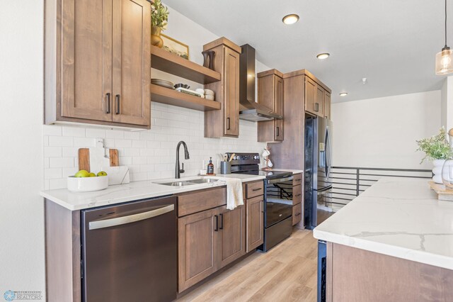 kitchen with wall chimney range hood, backsplash, open shelves, a sink, and stainless steel appliances