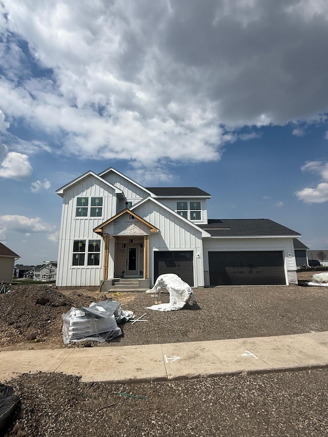 10155 Arrowwood Trl, Woodbury, MN 55129 - view of front of property with a garage and gravel driveway