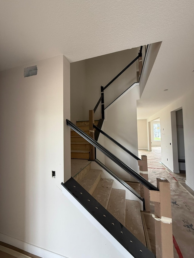 10155 Arrowwood Trl, Woodbury, MN 55129 - stairs featuring baseboards