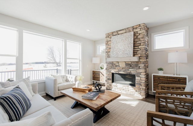 10155 Arrowwood Trl, Woodbury, MN 55129 - living area with a stone fireplace, wood finished floors, and baseboards