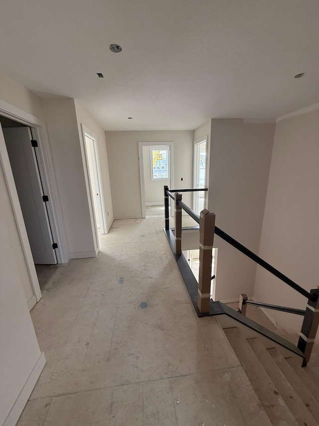 10155 Arrowwood Trl, Woodbury, MN 55129 - corridor with baseboards and an upstairs landing