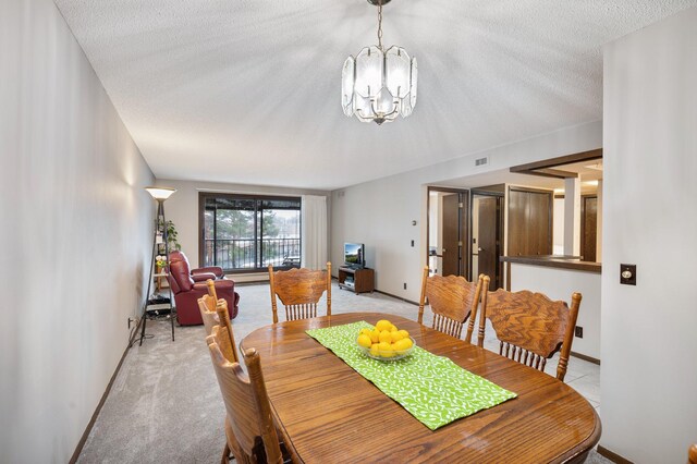 4710 58th Ave N Unit 219, Crystal, MN 55429 - dining space featuring a chandelier, a textured ceiling, and light carpet