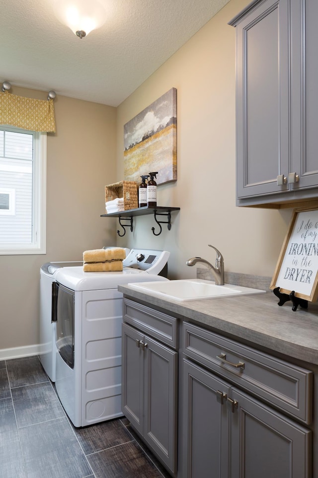 laundry area with washer and dryer, wood finish floors, cabinet space, and a sink