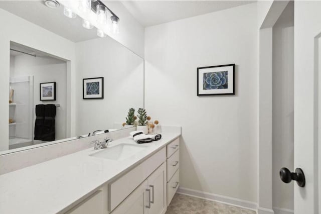 bathroom with vanity and baseboards