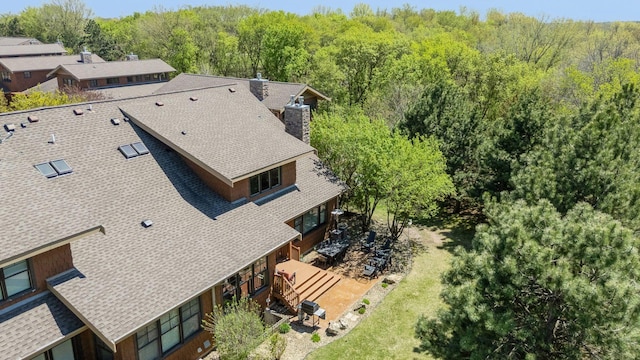 drone / aerial view featuring a forest view