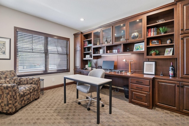 office space featuring built in desk, light colored carpet, baseboards, and recessed lighting