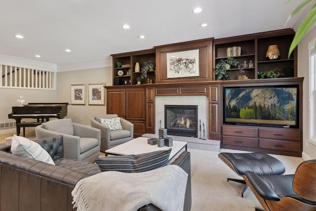 living area with crown molding, a high end fireplace, visible vents, and recessed lighting