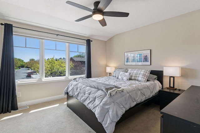 bedroom with carpet, visible vents, vaulted ceiling, ceiling fan, and baseboards