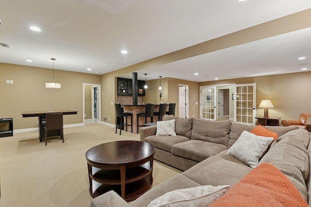 living room with light carpet, baseboards, and recessed lighting