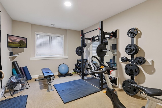 workout room with baseboards and carpet flooring