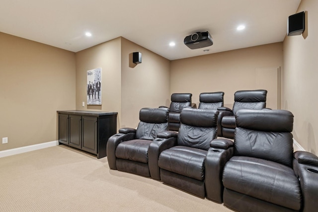 cinema room featuring baseboards, light carpet, and recessed lighting