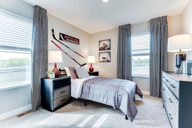 bedroom with light colored carpet, baseboards, and visible vents