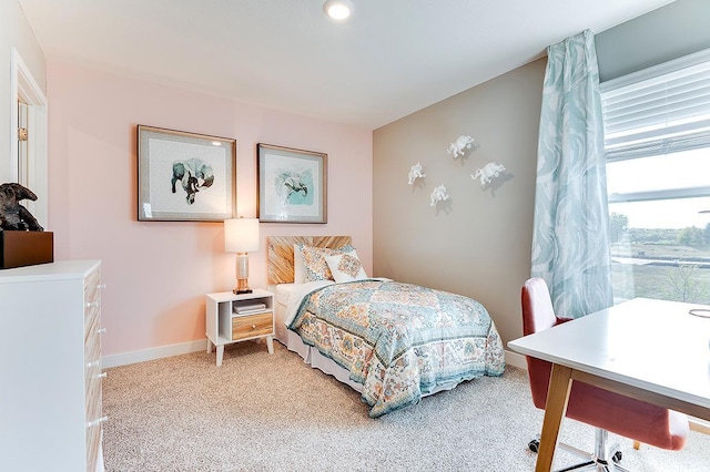 bedroom featuring baseboards and light colored carpet