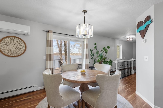 4991 337th Ave NE, Cambridge, MN 55008 - dining area featuring a baseboard radiator, a wall mounted AC, a chandelier, healthy amount of natural light, and a textured ceiling