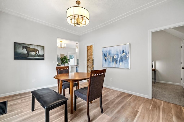 dining space with light wood-style floors, visible vents, baseboards, and an inviting chandelier