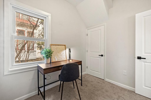 office area featuring vaulted ceiling, carpet floors, and baseboards