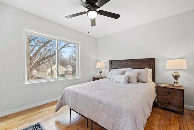 bedroom with hardwood / wood-style flooring, baseboards, and ceiling fan