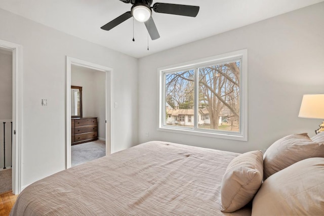 bedroom with a ceiling fan and baseboards