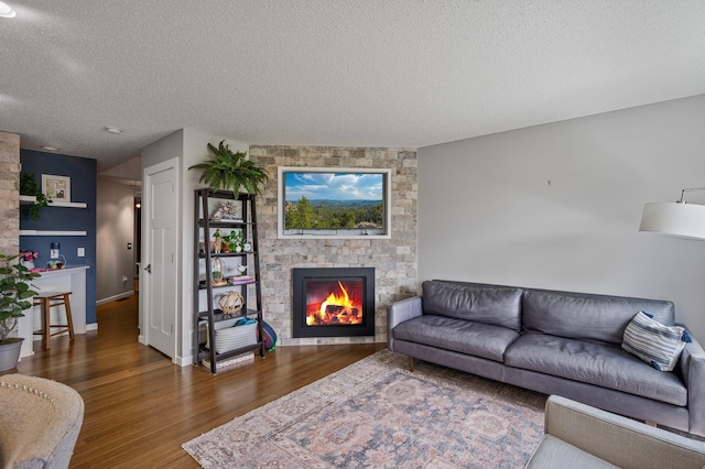 10351 Kittredge Pkwy NE, Otsego, MN 55301 - living area with a textured ceiling, a large fireplace, and wood finished floors