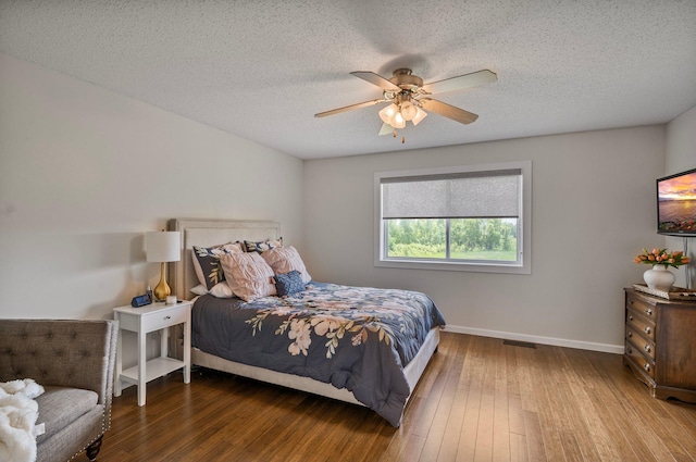 10351 Kittredge Pkwy NE, Otsego, MN 55301 - bedroom with hardwood / wood-style floors, a textured ceiling, and a ceiling fan