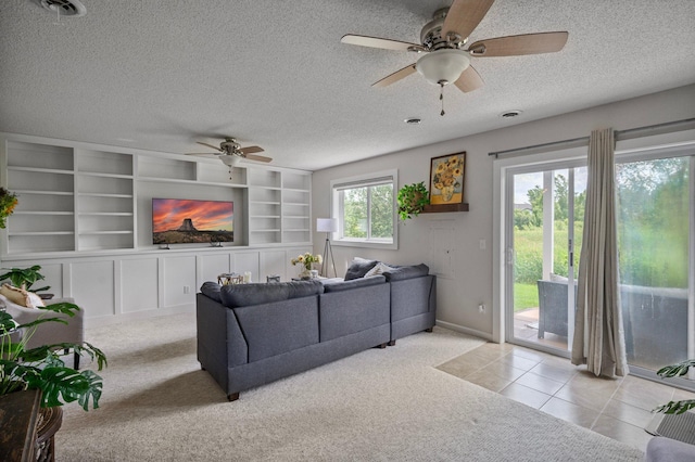 10351 Kittredge Pkwy NE, Otsego, MN 55301 - carpeted living room featuring a ceiling fan, a textured ceiling, tile patterned flooring, and built in shelves