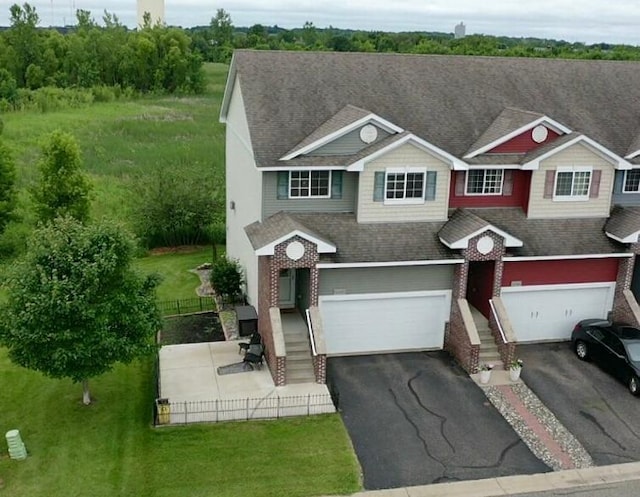 10351 Kittredge Pkwy NE, Otsego, MN 55301 - view of front of home with an attached garage, asphalt driveway, a shingled roof, and brick siding