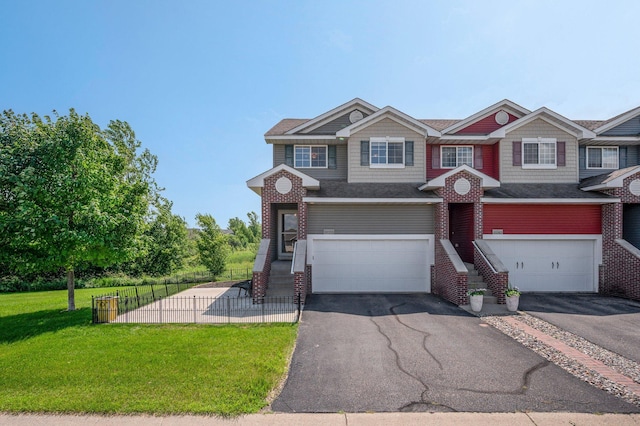 10351 Kittredge Pkwy NE, Otsego, MN 55301 - view of front of home featuring asphalt driveway, a garage, and brick siding