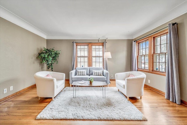 living room with baseboards, ornamental molding, and wood finished floors