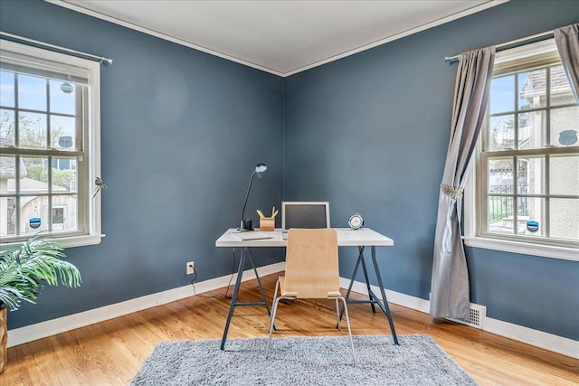office with crown molding, plenty of natural light, and wood finished floors