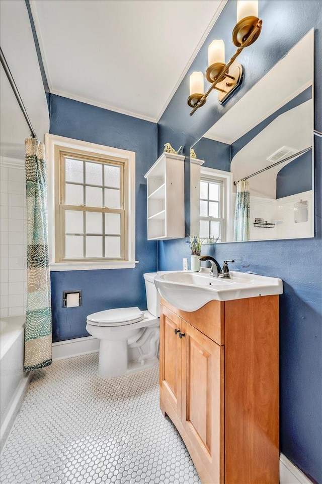 bathroom featuring vanity, ornamental molding, shower / bath combination with curtain, and toilet