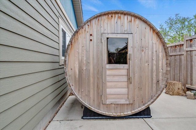 view of shed featuring fence