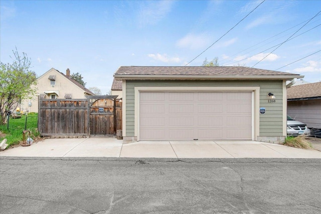 detached garage featuring fence