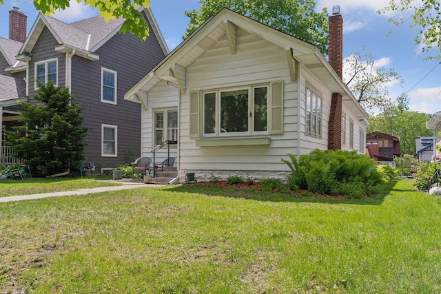 5236 Vincent Ave S, Minneapolis, MN 55410 - view of front of house with a chimney, a front lawn, and roof with shingles