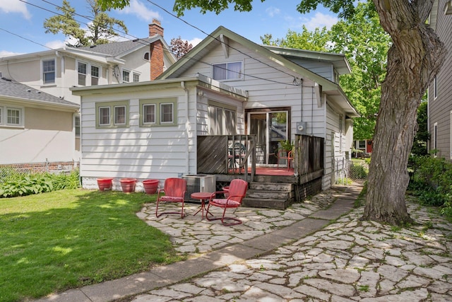 5236 Vincent Ave S, Minneapolis, MN 55410 - back of house featuring a lawn, central air condition unit, a patio area, and a wooden deck