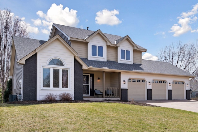 view of front of house featuring a front lawn, driveway, covered porch, brick siding, and an attached garage
