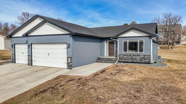 ranch-style house with a front yard, stone siding, a garage, driveway, and roof with shingles