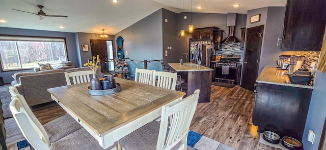 dining room featuring dark wood-type flooring, a ceiling fan, lofted ceiling, and recessed lighting