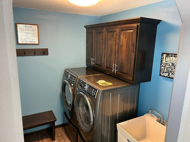 laundry room with independent washer and dryer, wood finished floors, a sink, and cabinet space