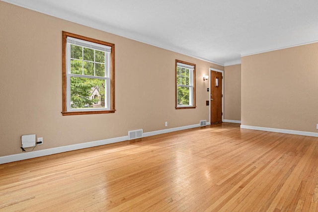 5319 38th Ave S, Minneapolis, MN 55417 - empty room with healthy amount of natural light, light wood-style flooring, baseboards, and crown molding