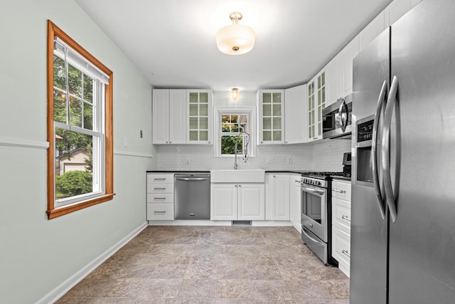 5319 38th Ave S, Minneapolis, MN 55417 - kitchen featuring appliances with stainless steel finishes, a sink, healthy amount of natural light, and decorative backsplash