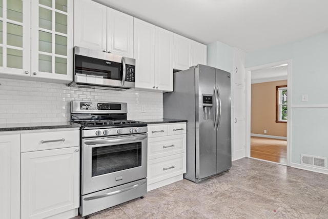 5319 38th Ave S, Minneapolis, MN 55417 - kitchen with stainless steel appliances, tasteful backsplash, glass insert cabinets, white cabinets, and baseboards