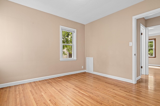 5319 38th Ave S, Minneapolis, MN 55417 - unfurnished room with light wood finished floors, baseboards, and plenty of natural light