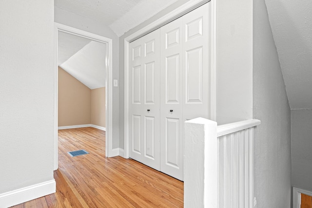 5319 38th Ave S, Minneapolis, MN 55417 - hallway featuring vaulted ceiling, light wood-style floors, and baseboards