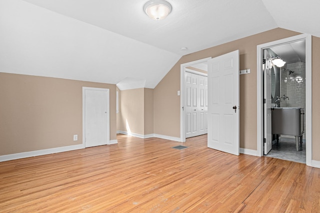 5319 38th Ave S, Minneapolis, MN 55417 - additional living space featuring vaulted ceiling, light wood-style floors, and baseboards