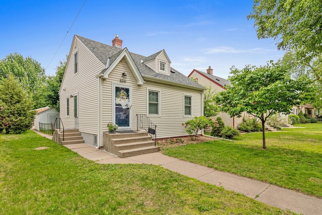 5319 38th Ave S, Minneapolis, MN 55417 - cape cod-style house with a front yard, a shingled roof, a chimney, and an outdoor structure