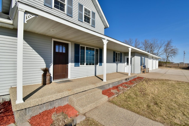40749 Greencrest Rd, Crow River Twp, MN 56312 - entrance to property with a garage, concrete driveway, and covered porch