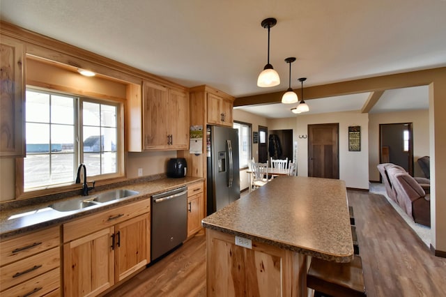 40749 Greencrest Rd, Crow River Twp, MN 56312 - kitchen with a center island, dark countertops, a sink, appliances with stainless steel finishes, and dark wood-type flooring