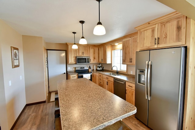 40749 Greencrest Rd, Crow River Twp, MN 56312 - kitchen featuring stainless steel appliances, wood finished floors, a sink, and a kitchen island